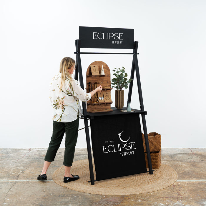 Black market stall with personalized board for Eclipse Jewelry pop-up