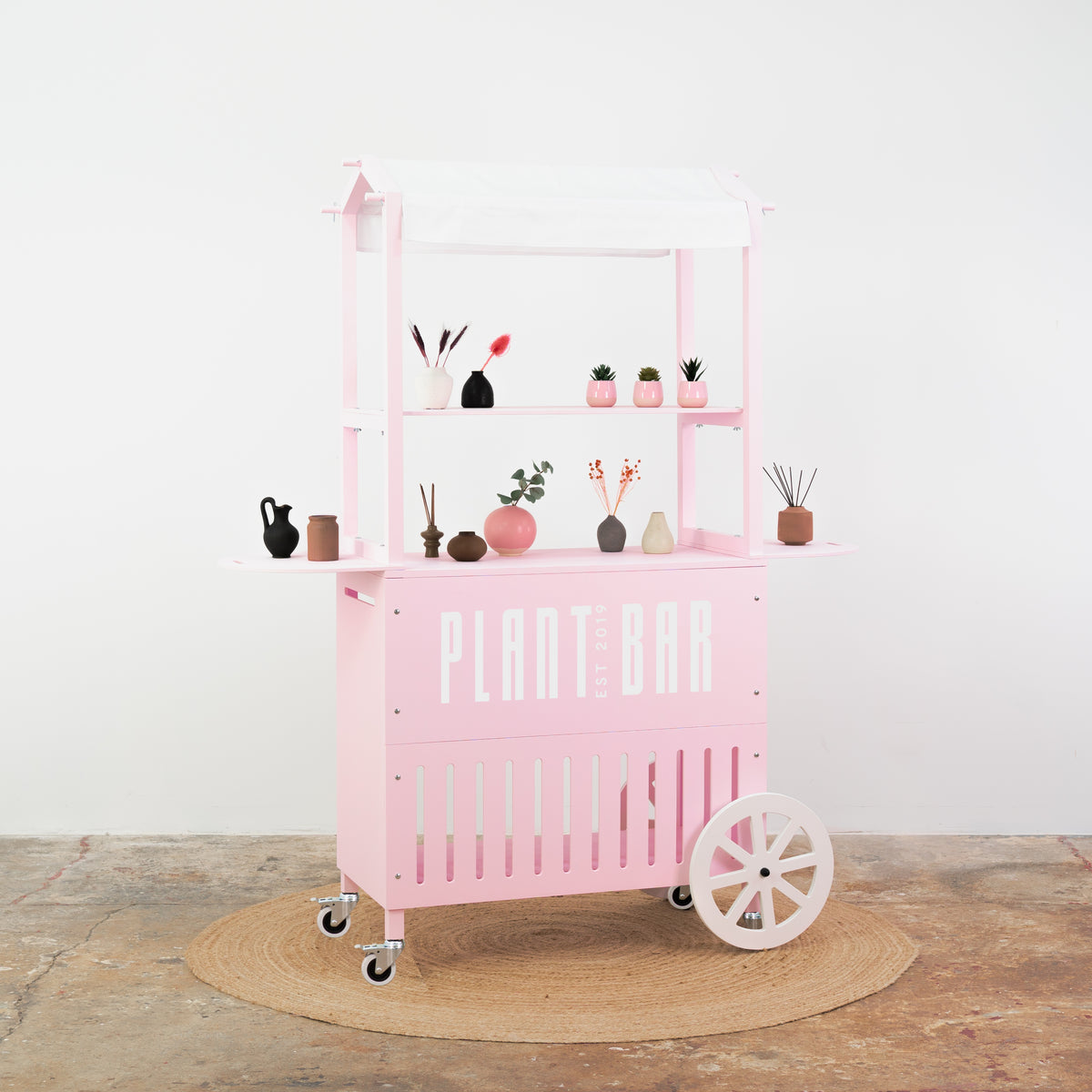Soft pink cart with white accents – beauty and makeup product display