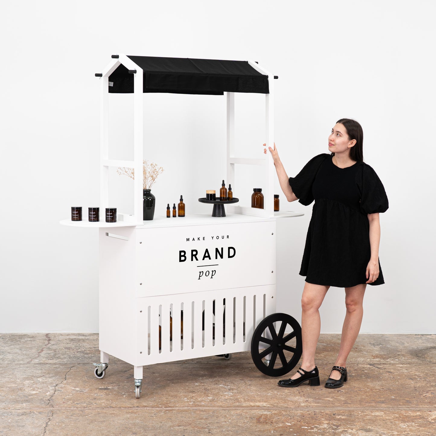 Customizable white display cart with sleek design, offering ample space for showcasing a range of products.