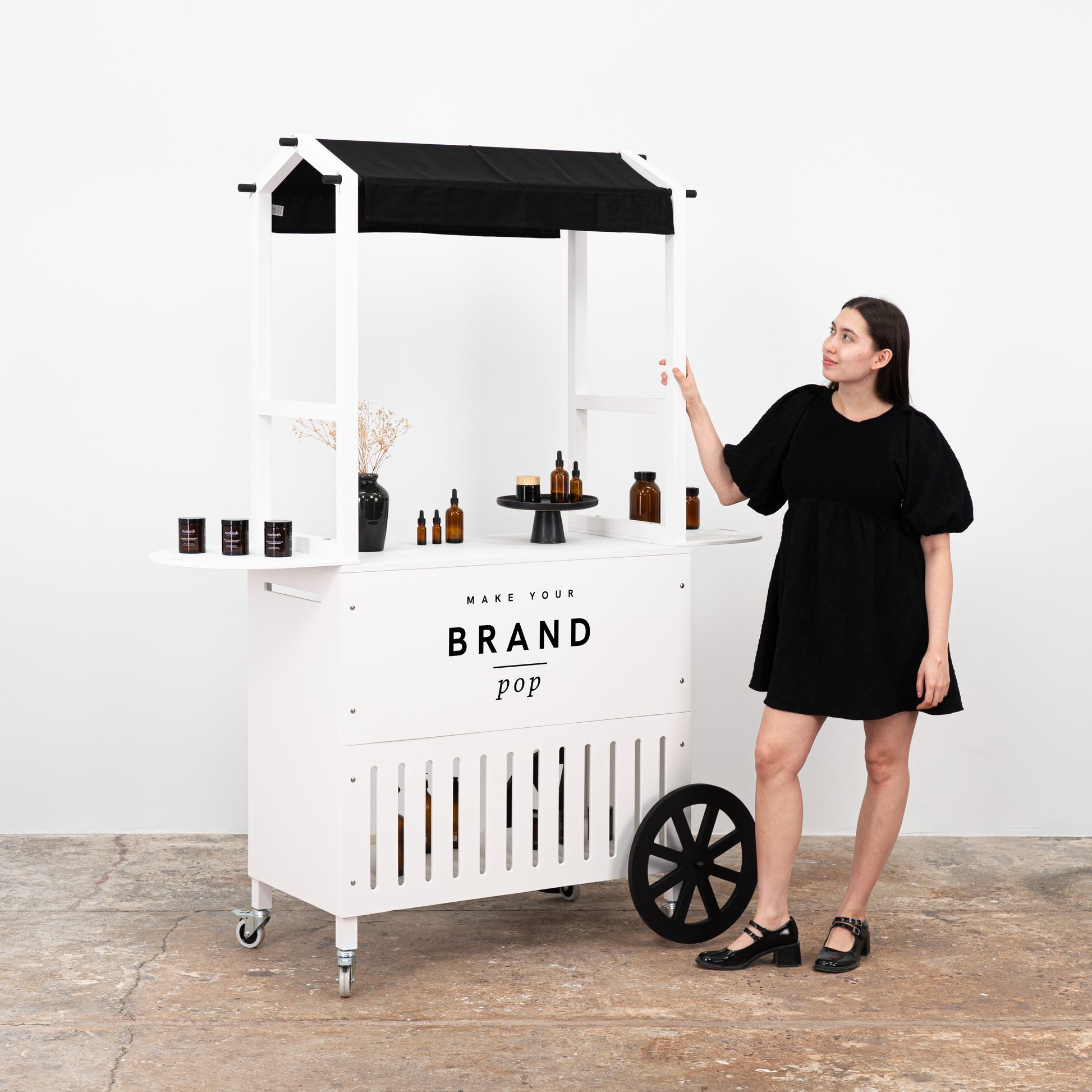 Customizable white display cart with sleek design, offering ample space for showcasing a range of products.