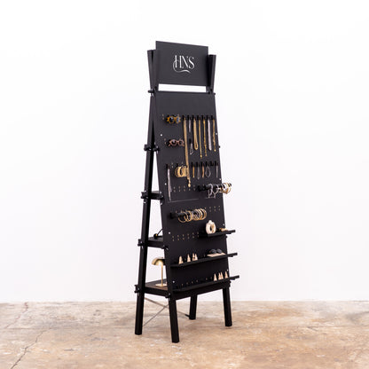 Matte black pegboard with adjustable hooks and rear shelf system