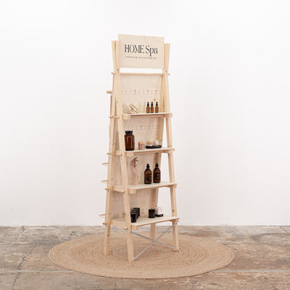 Natural wood pegboard stand with hooks, shelves, and branding space, designed for compact showrooms and mobile retail setups.