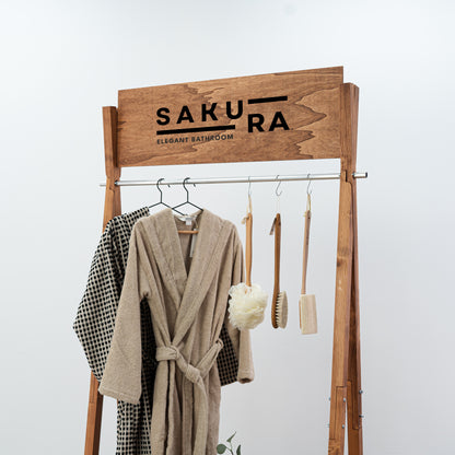 Portable A-frame retail rack in warm wood tone with folded items on bottom shelf