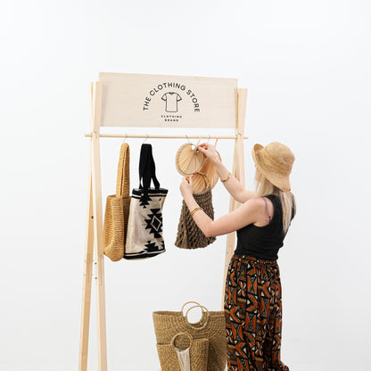 A-frame garment rack made of birch wood with signage panel