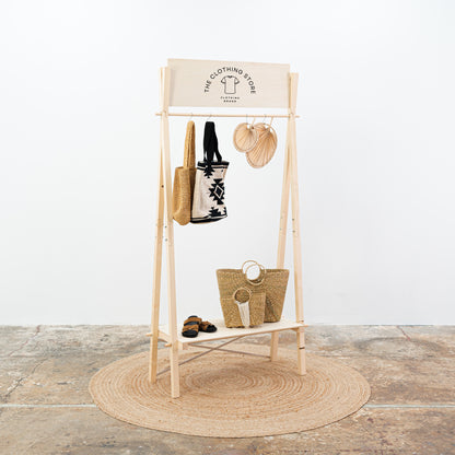 Foldable wooden display stand in natural finish with robe and shoes