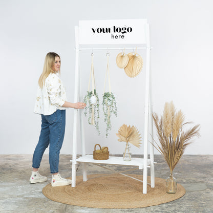 Bright retail setup with white wooden clothing rack