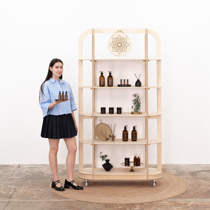 Natural wood retail shelving unit styled with skincare and fragrance items