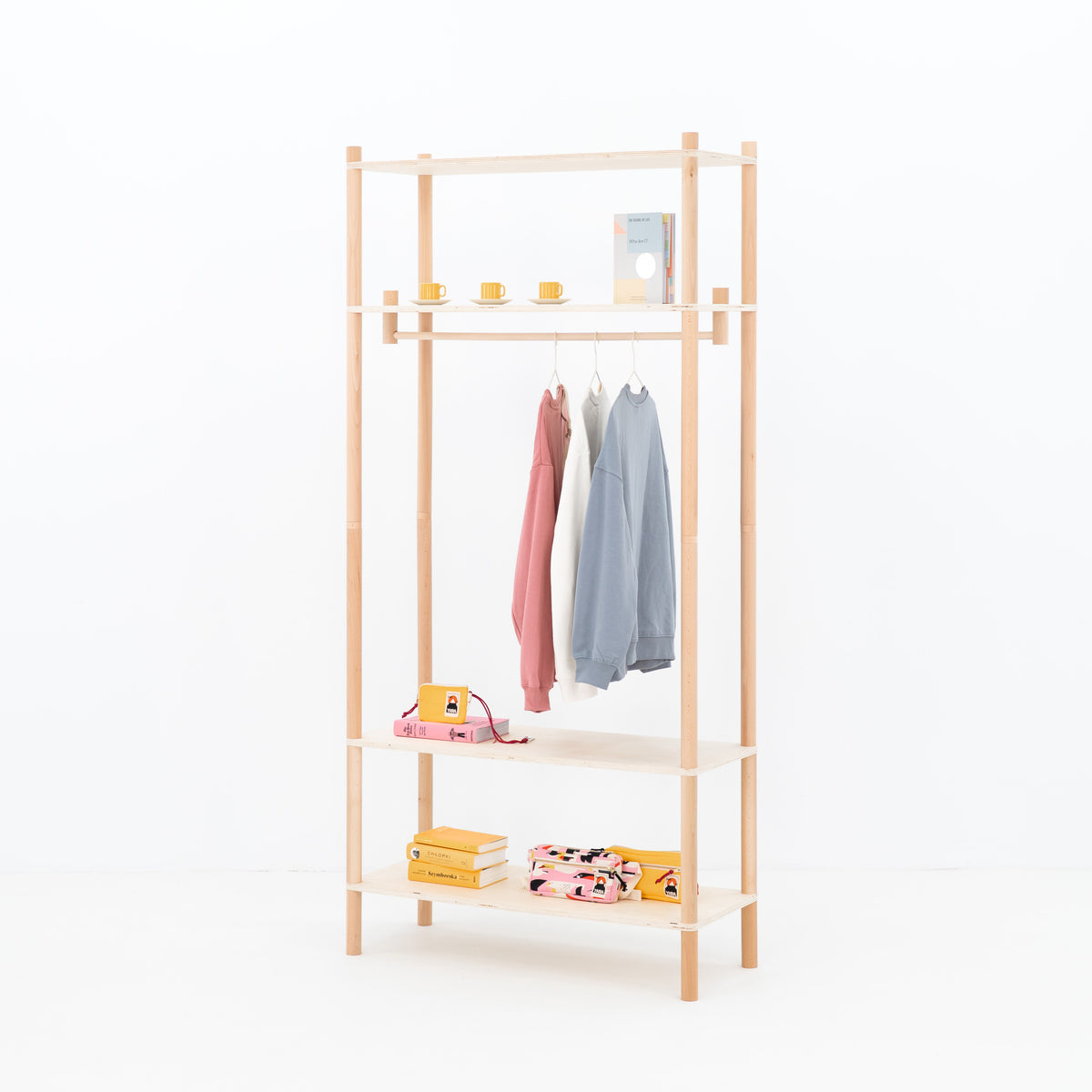 Display rack with pink blazer and accessories on shelf