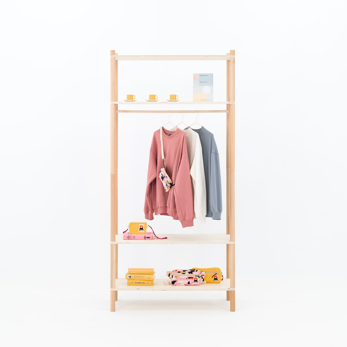 Double-sided BAMBUK garment rack with pink and gray clothes on hangers