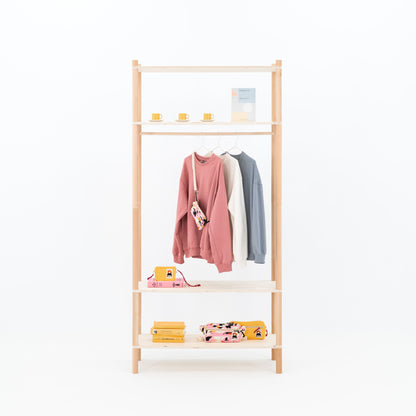 Double-sided BAMBUK garment rack with pink and gray clothes on hangers