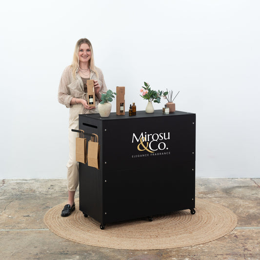 Black checkout counter with logo branding panel, front view.