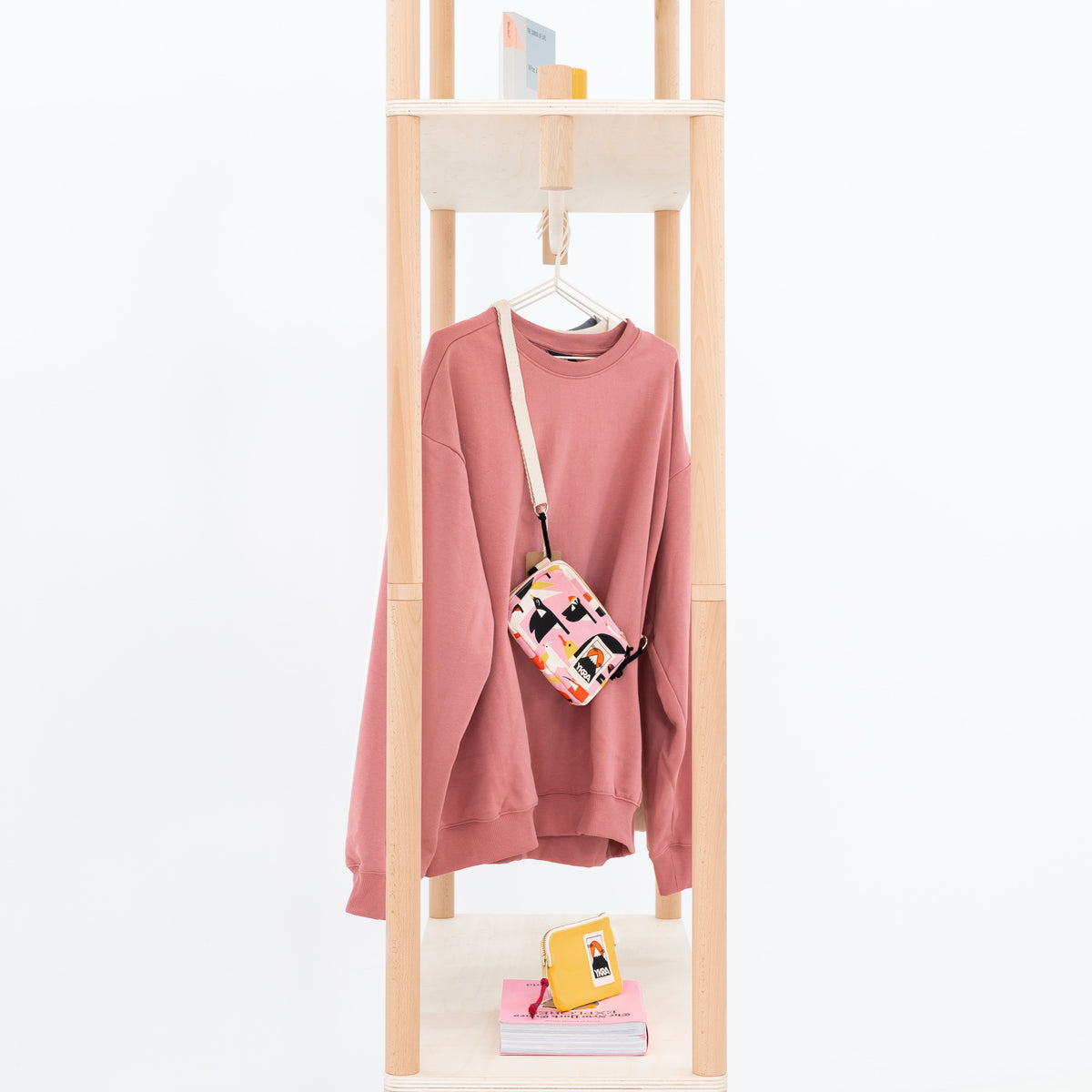 Side view of wooden garment rack with lower shelves