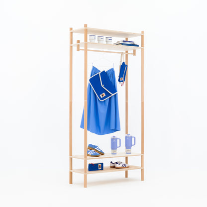 Minimal wooden garment rack with bottom shelf for retail setup
