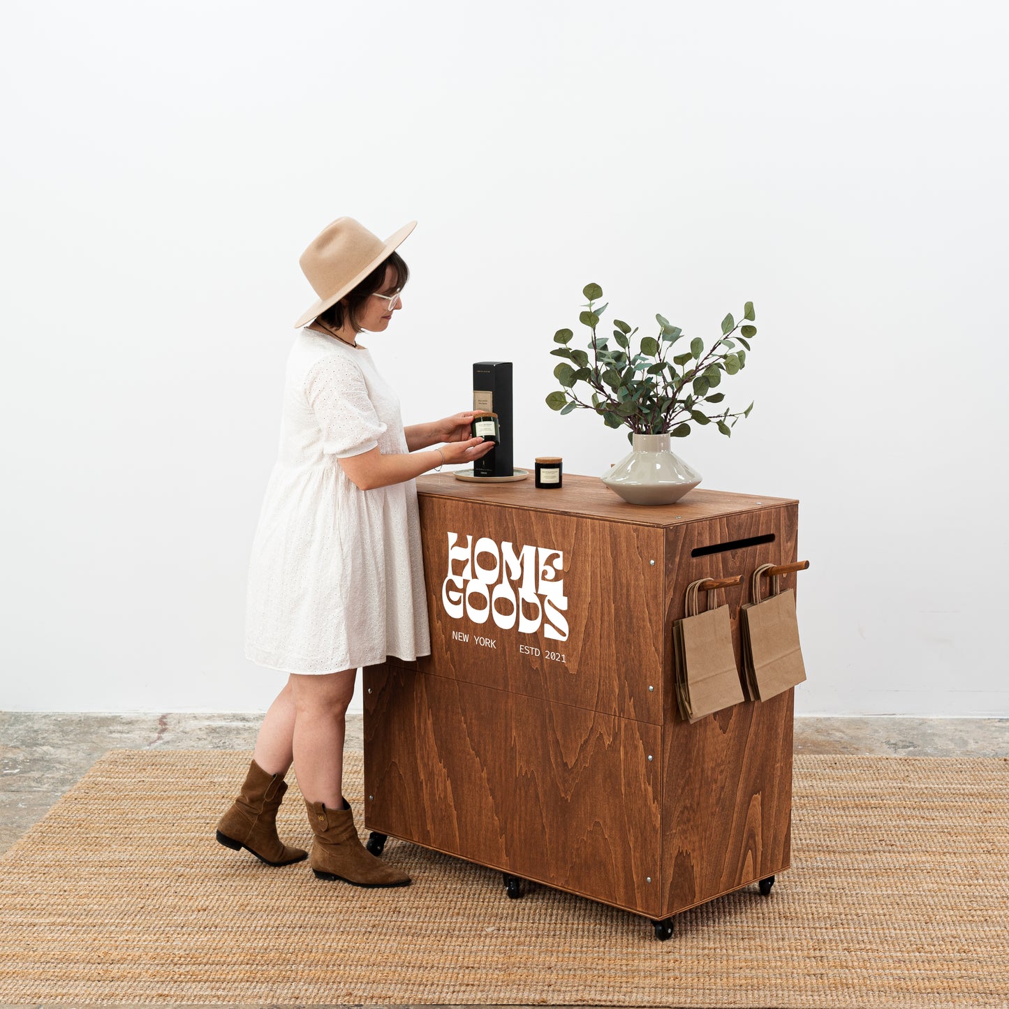 Mobile pop-up shop display counter with wheels and compact design.