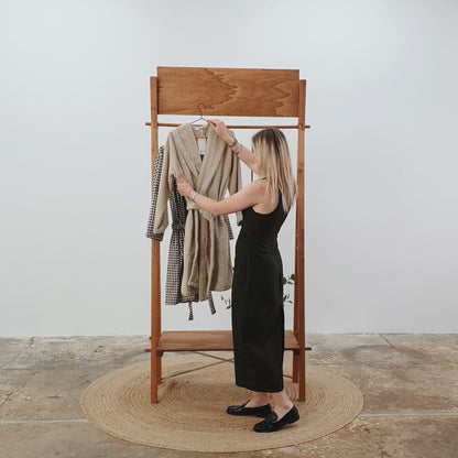 Folding wooden garment rack with branded sign and interchangeable rods – product demo