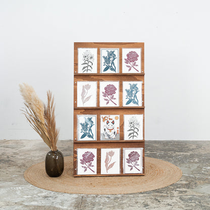 Foldable catalog stand in dark wood, front view with stacked brochures